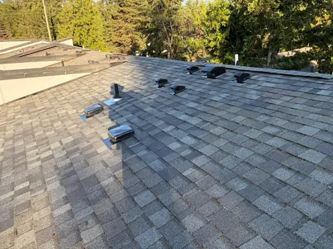 Finished gray shingle roof after roofing work