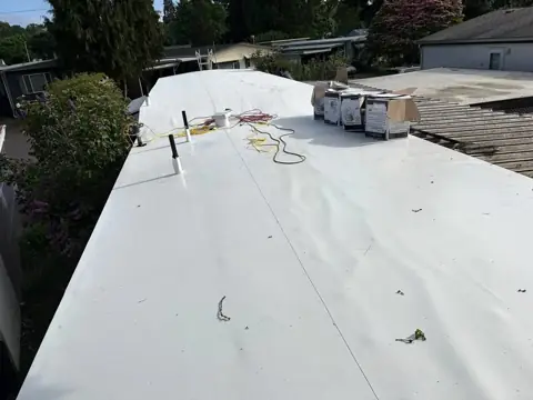 Completed white low-slope roof membrane after installation