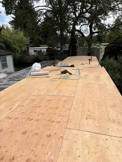 New plywood roof deck during low-slope roof preparation