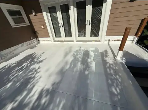 Finished white waterproof deck membrane beside exterior doors