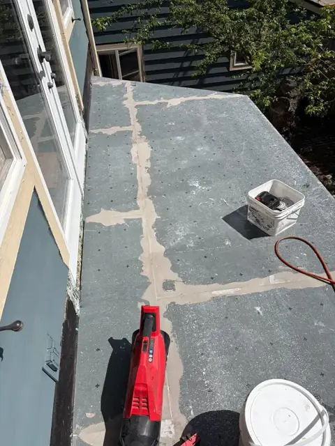 Small flat roof surface with patched seams before waterproofing